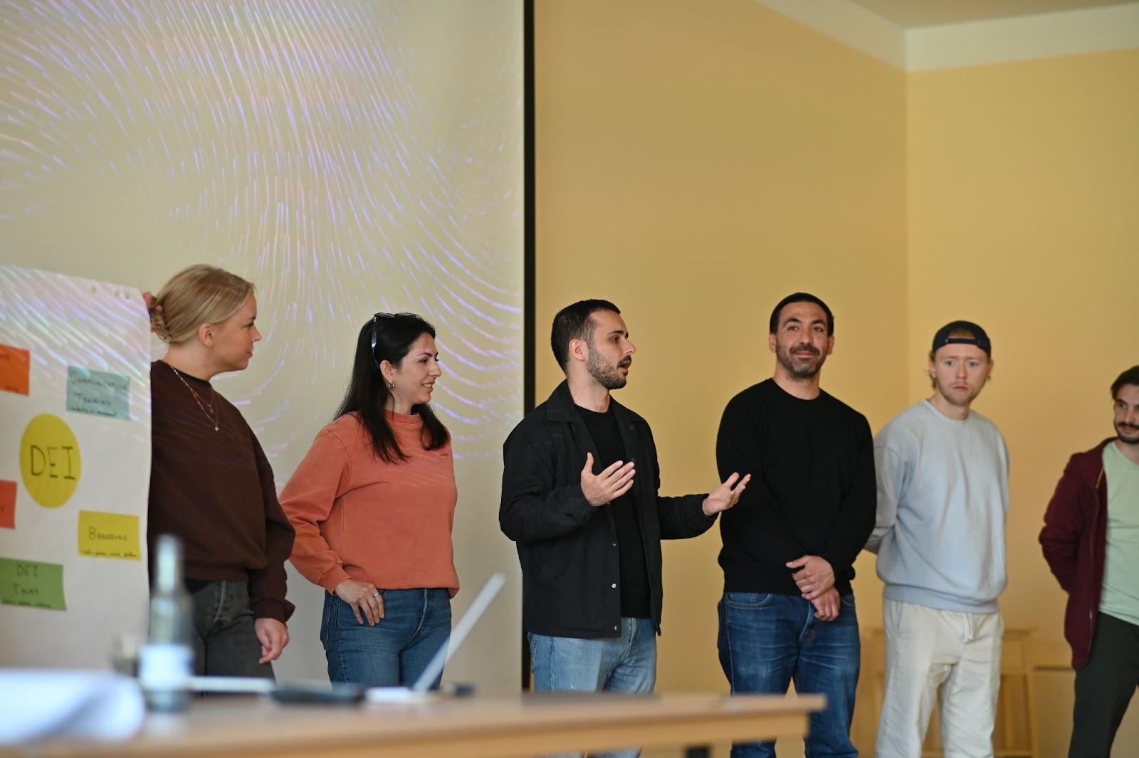 Photo of a group of employees presenting their pitch for DEI initiatives at Leapsome