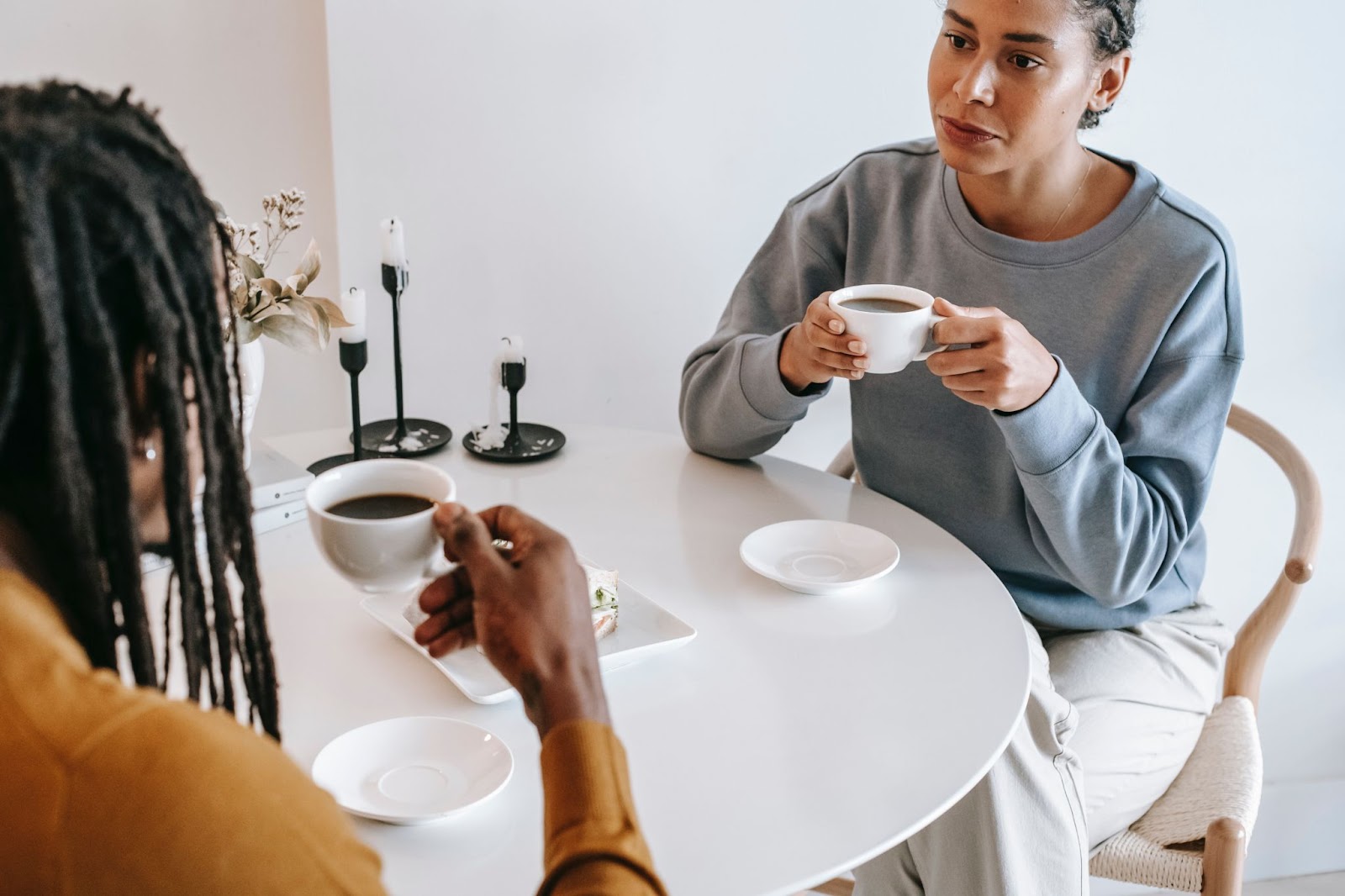 Two people drinking coffee comfortably