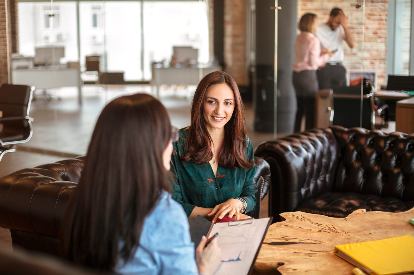 Photo of two people talking in the workplace