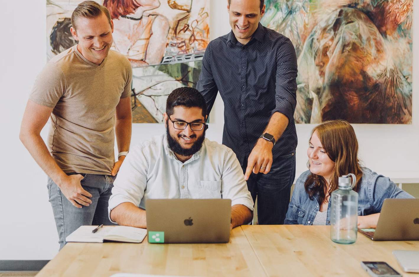 Photo of four of happy employees working together