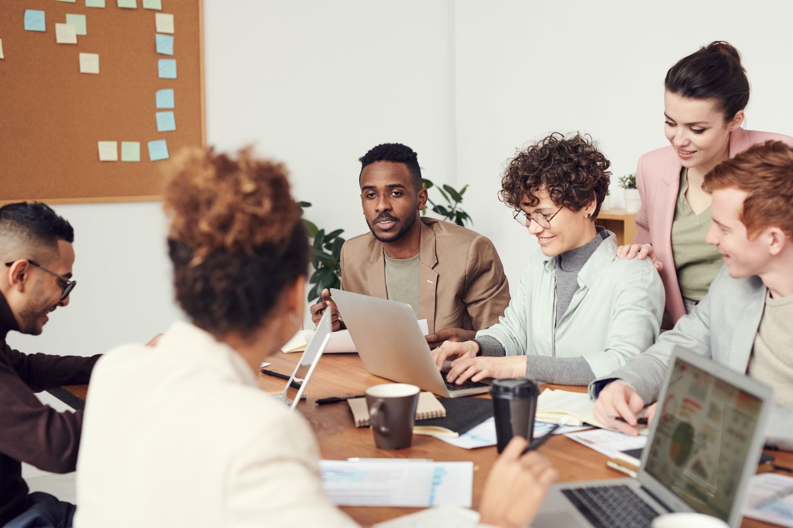 Photo of a group of colleagues gathered for an informal office meeting