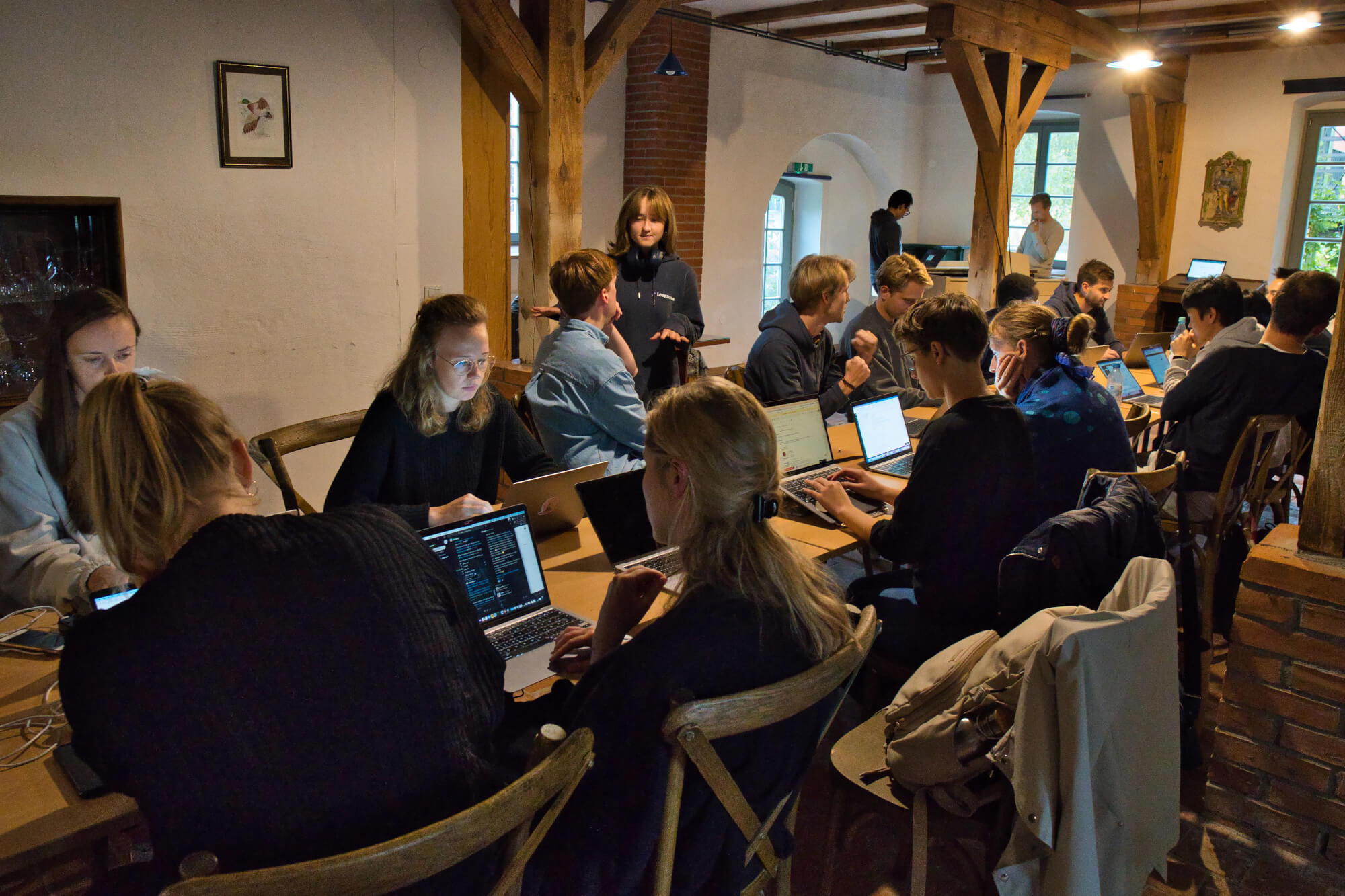 Leapsome team members sitting next to one another and using their laptops during the company’s 2021 offsite