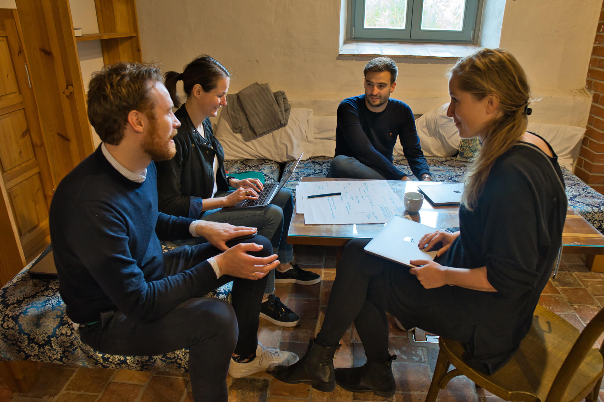 Four members of Leapsome working together and talking during the company’s 2021 offsite