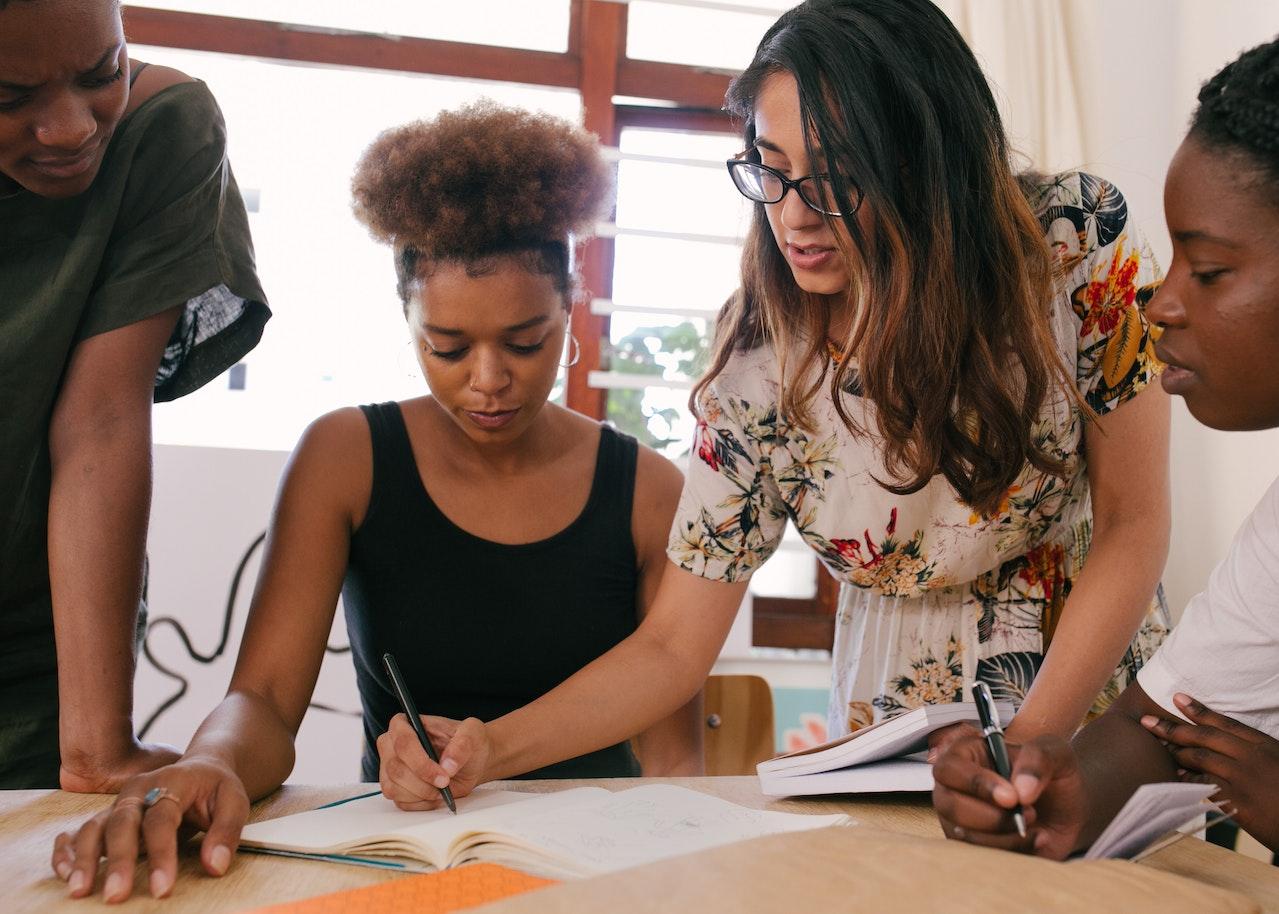 Photo of a group of professionals working on a strategic plan around a table.