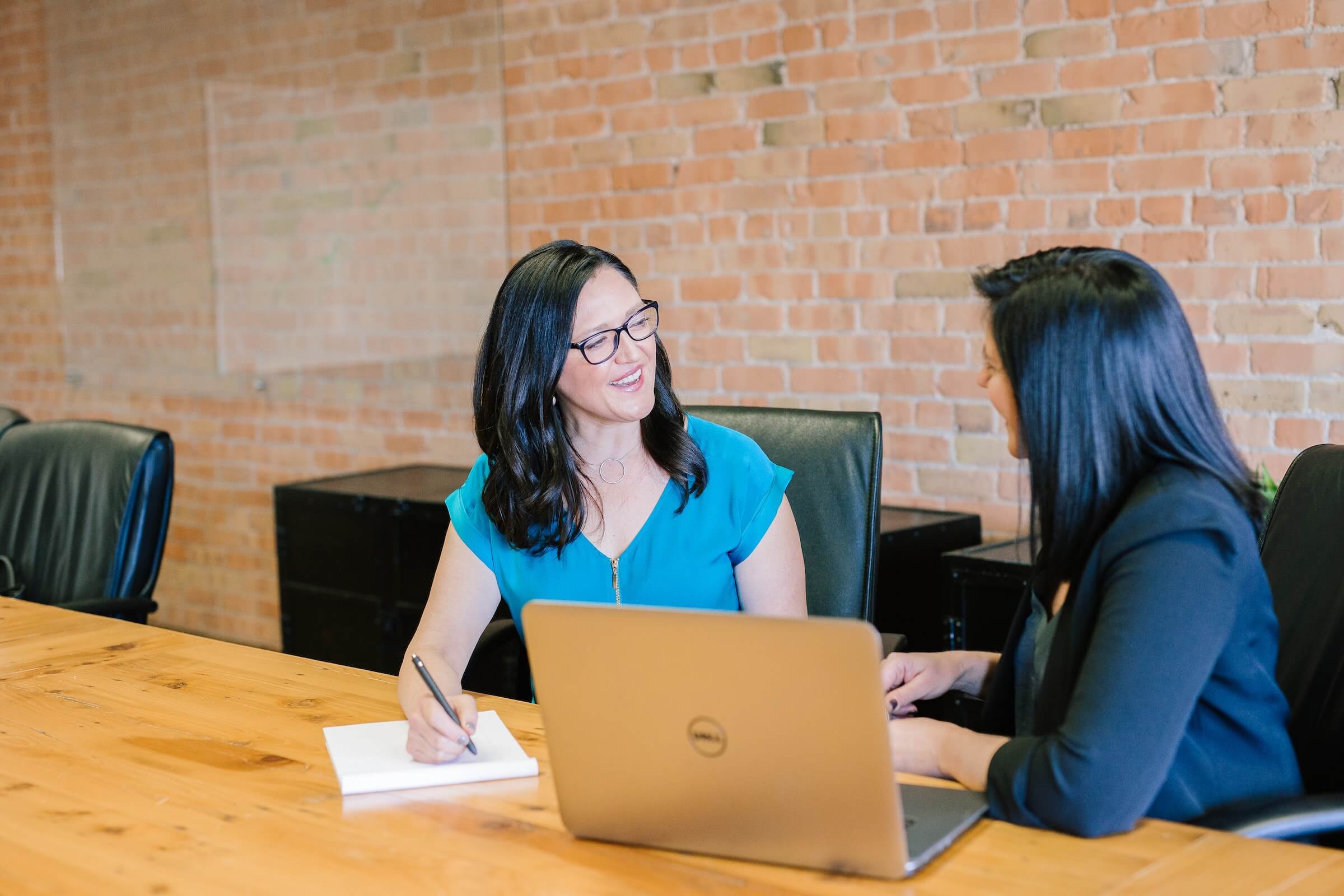 A photo of two professionals engaged in a performance review meeting.