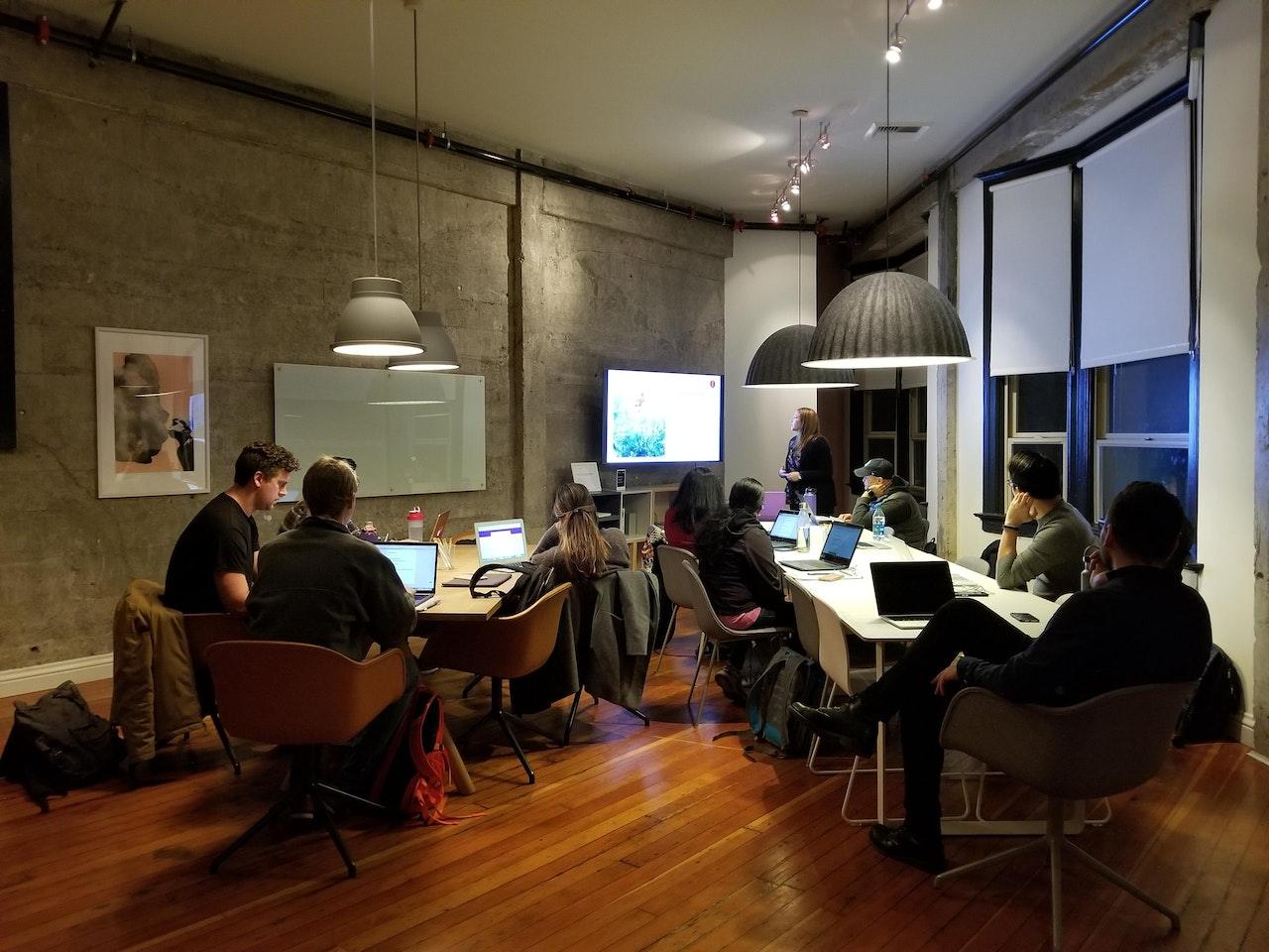 Photo of an office space full of professionals following a presentation.