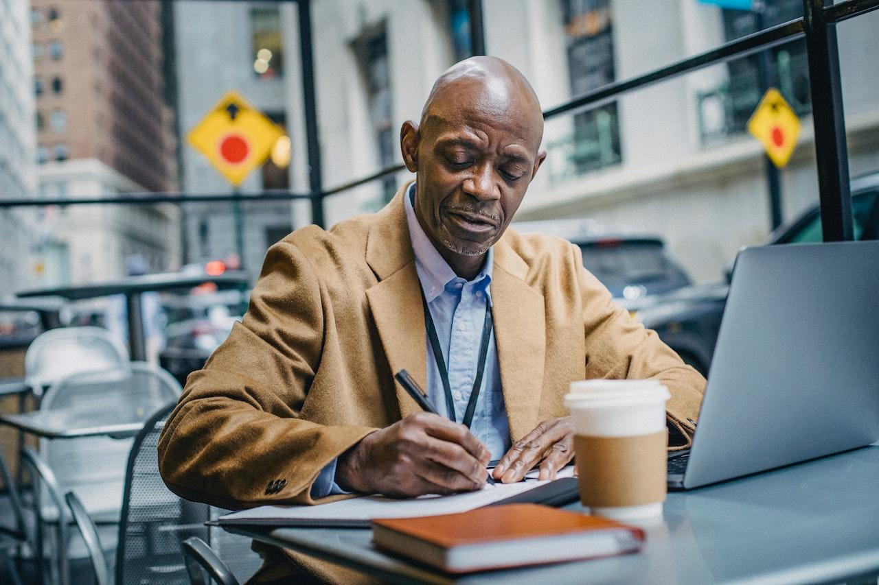 A photo of a remote employee working from a laptop.