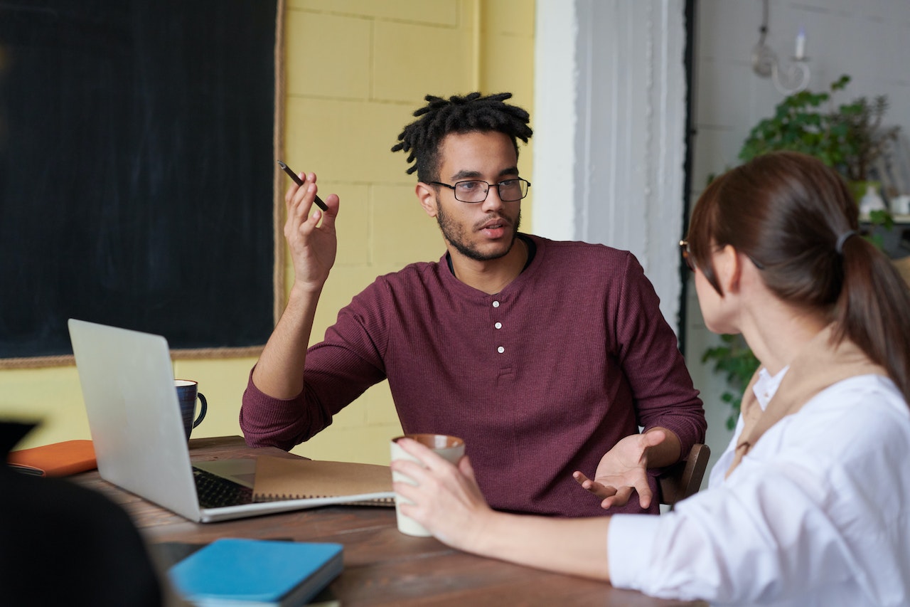 A photo of two employees collaborating on a task.