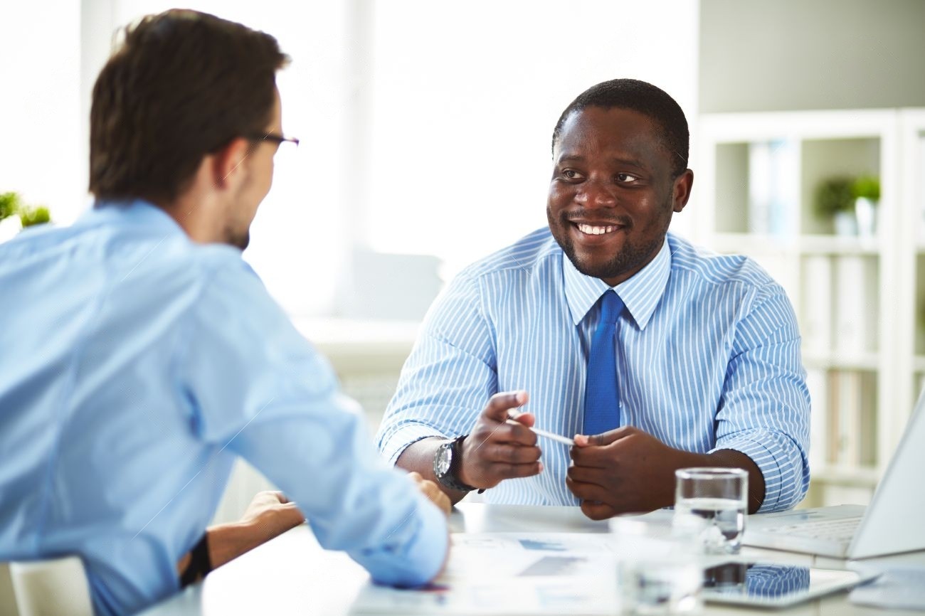 A photo of a manager speaking with an employee.