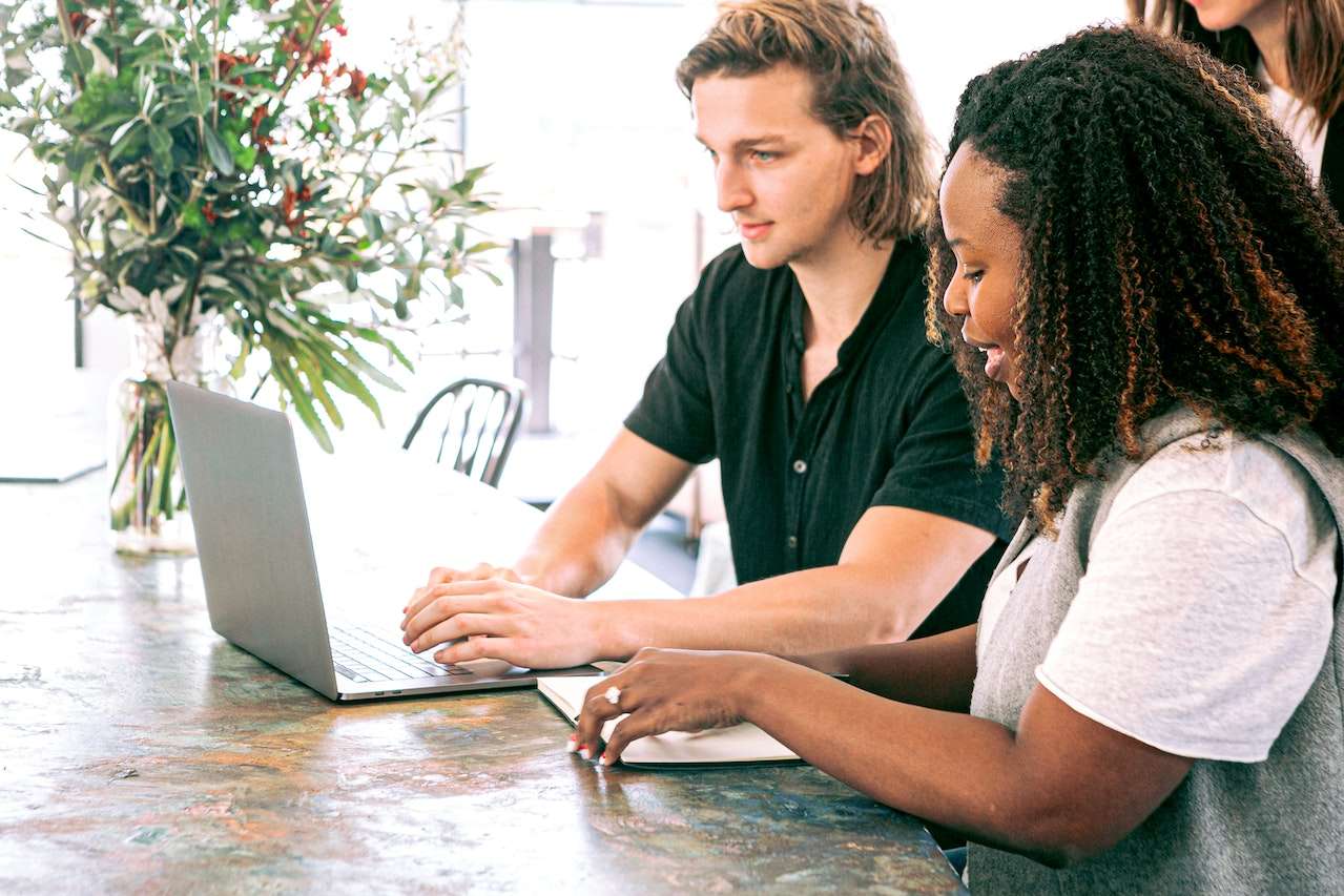 A photo of two employees working together.