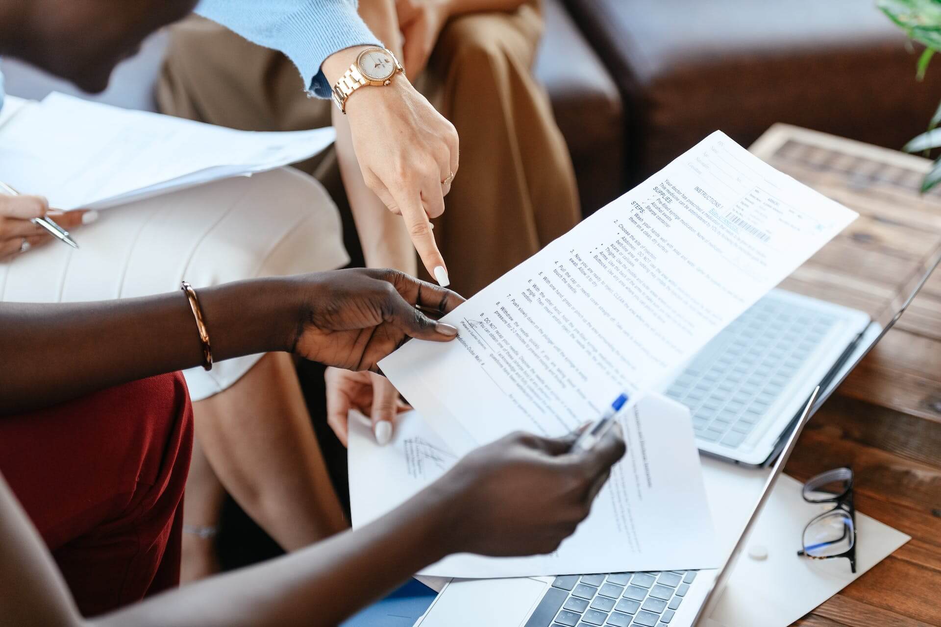 Photo of a diverse group of employees reviewing a document.