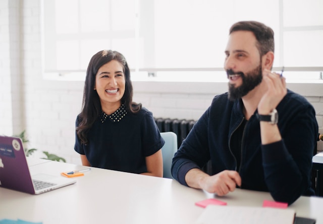 A photo of an employee celebrating their colleague at work.