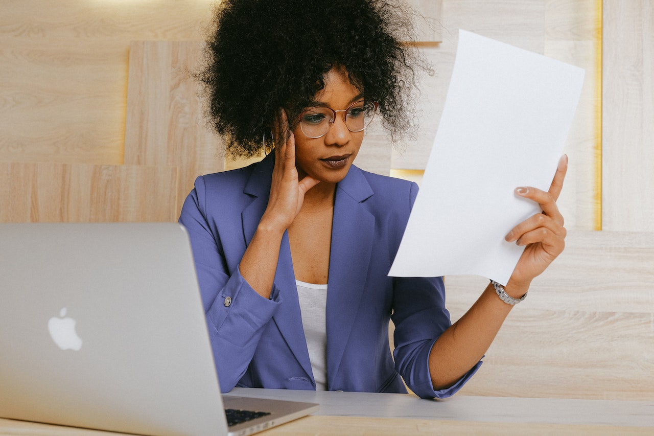 Photo of a professional reading a retention agreement at their desk.