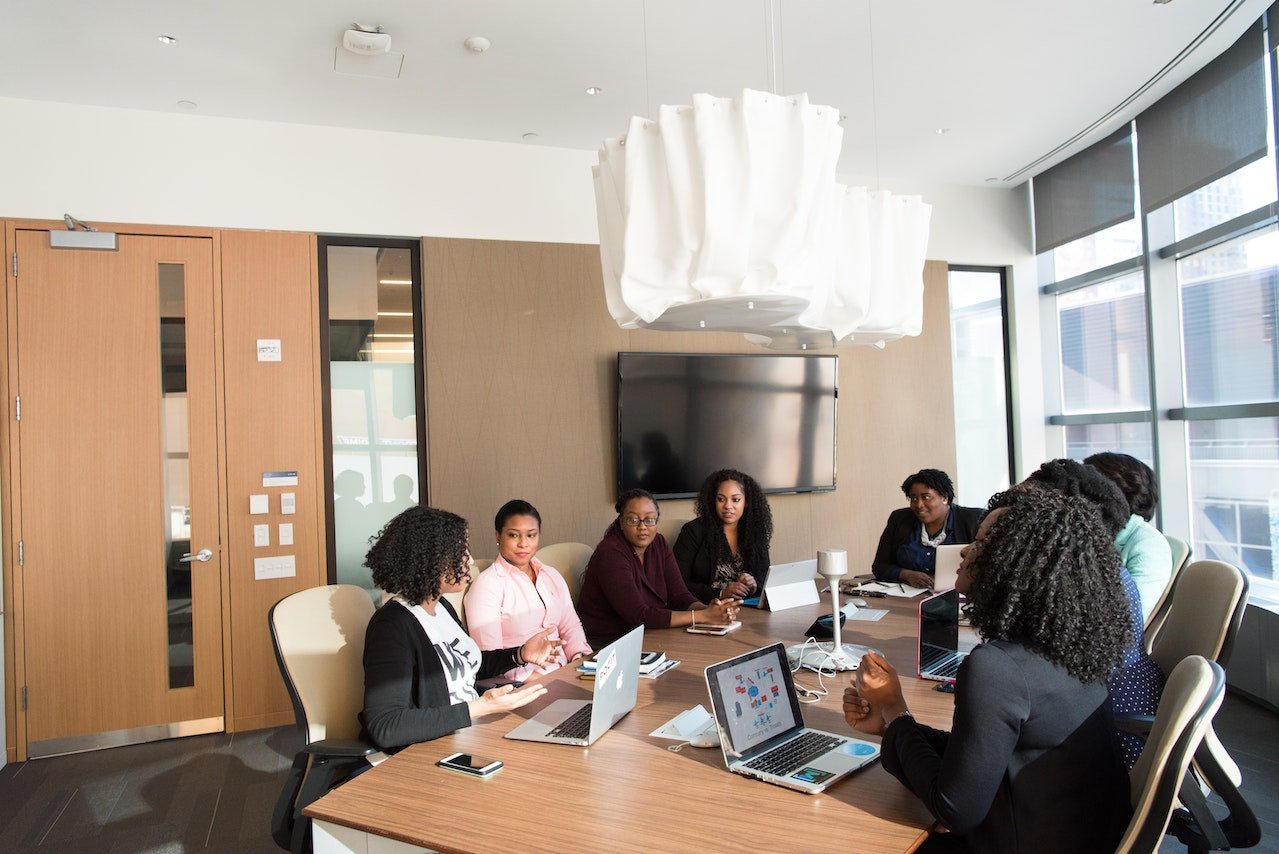 A photo of a large group of employees at a meeting.